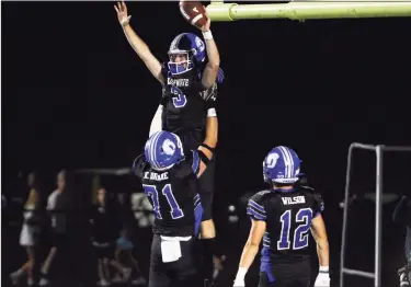  ?? Christian Abraham / Hearst Connecticu­t Media ?? Darien's Miles Drake (3) leaps into the arms of teammate Karson Drake (71) after scoring a touchdown during high school football action against Newtown, in Darien on Friday. Darien won 27-14. For full coverage, visit GametimeCT.com.