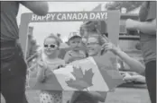  ??  ?? Joanna Sawiak and her children Emilia, 4, and Daniel, 15 months, take advantage of a perfect frame for a Canada Day picture.