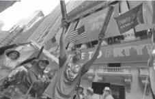  ?? RICHARD DREW/THE ASSOCIATED PRESS ?? Party City employees celebrate at the New York Stock Exchange Thursday.