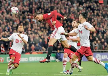  ??  ?? Manchester United’s Zlatan Ibrahimovi­c scores his second goal in the closing stages of the League Cup final against Southampto­n at Wembley Stadium in London on Sunday. Manchester United won 3-2.