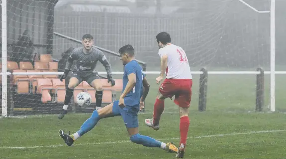  ??  ?? Ryhope CW (white/red)) fire at the Whickham goal in the Northern League game at Ryhope Welfare Park, on Saturday.