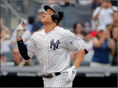  ??  ?? New York Yankees’ Aaron Judge reacts as he heads down the third base line after hitting a solo home run against the Atlanta Braves during the seventh inning of a baseball game on Wednesday.
AP PhoTo/JulIe JAcobson