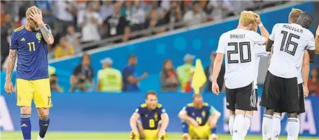  ?? STU FORSTER/GETTY IMAGES ?? Sweden player John Guidetti (left) and teammates react on the final whistle during the 2018 FIFA World Cup Russia group F match between Germany and Sweden.