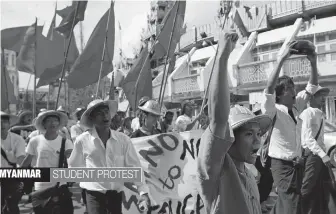  ?? — AP ?? University students march to protest against the national education law on Monday in central Yangon, Myanmar. Hundreds of Myanmar students marched through the streets of Yangon for the fourth day in a row, urging the government to amend the recently-...