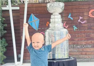  ?? KRISTINA HJERTKVIST THE ASSOCIATED PRESS ?? Kameron Bush, 3, poses with the Stanley Cup at the Children’s Cancer Center in Tampa, Fla.