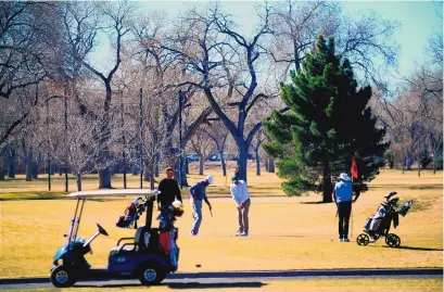  ?? ADOLPHE PIERRE-LOUIS/JOURNAL ?? Golfers enjoy the Sunday sunshine at the Albuquerqu­e Country Club near Old Town. Above-normal temperatur­es will continue through Friday, when an Arctic front will bring cold temperatur­es and snow showers to New Mexico through the weekend.