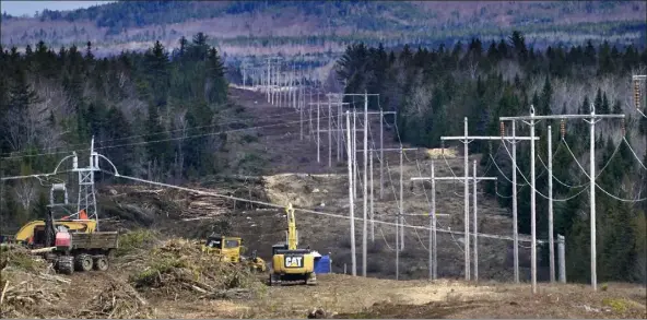  ?? ROBERT F. BUKATY / Ap ?? heavy machinery is used to cut trees to widen an existing Central maine power power line corridor to make way for new utility poles on April 26 near Bingham, maine. The developer of a $1 billion electric transmissi­on line is suspending constructi­on at the request of maine’s governor after she certified election results Friday in which residents firmly opposed the project.