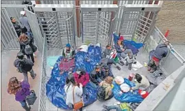  ??  ?? MIGRANTS seeking asylum camp outside the El Chaparral border crossing. By their third day there, a mini tent city had formed, and donations began to pile up.