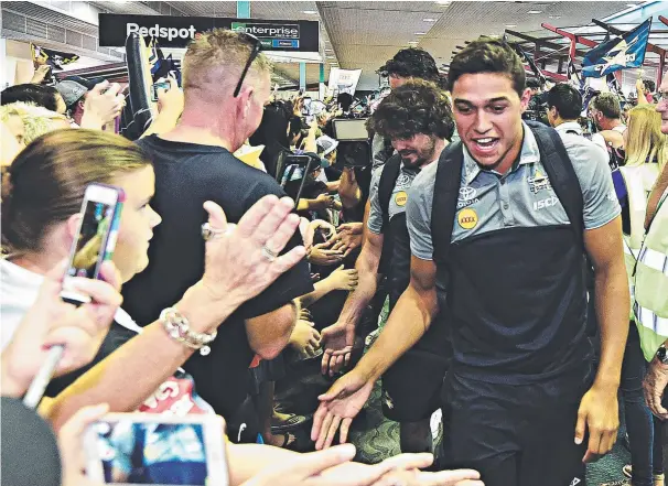  ?? YEEHA: Te Maire Martin greets fans at Townsville Airport yesterday; ( inset left), Giselle O’Neill welcomes dad Justin O’Neill. Pictures: EVAN MORGAN, SCOTT RADFORD- CHISHOLM ??