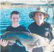  ??  ?? Trainer Scott Morrisey with nephew Jay Young who caught an 85cm Murray cod.