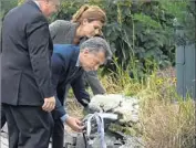  ?? Timothy A. Clary AFP/Getty Images ?? ARGENTINE President Mauricio Macri, center, with wife Juliana and New York Mayor Bill de Blasio, pays tribute to the victims of the bike path attack.