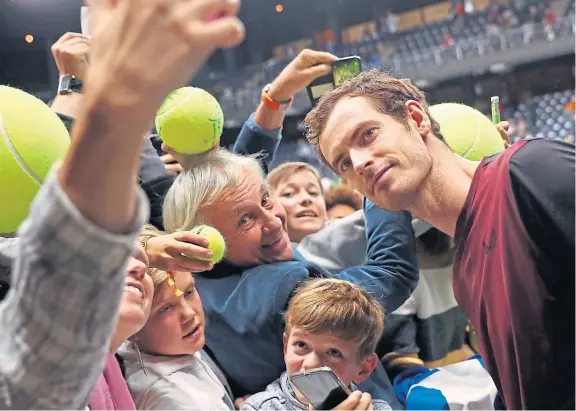  ?? Picture: AP. ?? Andy Murray poses for photograph­s with fans after winning the European Open in Antwerp, Belgium.