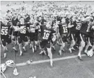  ?? ARMY ATHLETICS ?? Navy celebrates after beating No. 5 Army 12-11 in overtime on Saturday in West Point, New York.