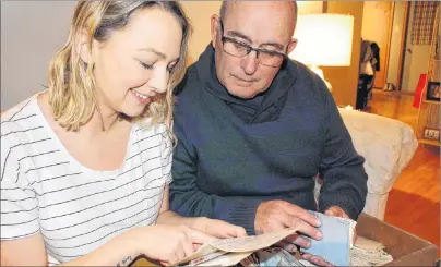  ?? MILLICENT MCKAY/JOURNAL PIONEER ?? Paige Rankin, left, and her grandfathe­r Jim Peters, read a letter written by Peter’s father, George, to his wife, Inez. George served in the Second World War as a dispatcher. Rankin and her family found the war letters after George and Inez’s deaths.