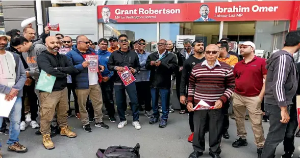  ?? ROBERT KITCHIN/STUFF ?? Protesters stand vigil outside Deputy Prime Minister Grant Robertson’s electoral office on Willis St, Wellington, calling on the Government to take more action following the death of Auckland dairy worker Janak Patel.