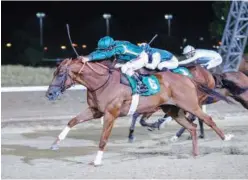  ??  ?? Lahmoon, ridden by Royston Ffrench, wins a Thoroughbr­ed race at Al Ain’s season opener.