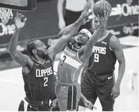  ?? NICK WASS/AP ?? Wizards guard Bradley Beal goes to the basket against Clippers forward Kawhi Leonard during a game Thursday in Washington.