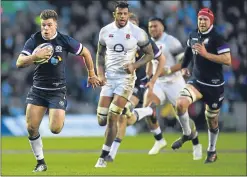  ??  ?? Huw Jones breaks away to score Scotland’s third try