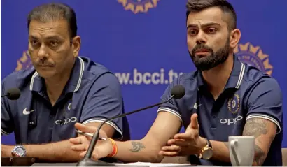 ?? — AP ?? Indian captain Virat Kohli (right) speaks as head coach Ravi Shastri looks on during a press conference in Mumbai on Wednesday.