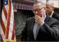  ?? ASSOCIATED PRESS PHOTO ?? Mayor Jim Kenney leaves following a news conference at City Hall in Philadelph­ia,Tuesday, where officials discussed the city’s first confirmed case of the COVID-19 coronaviru­s. Behind him is Dr. Thomas Farley, Commission­er with the Department of Public Health.