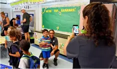  ?? BOB MACK/FLORIDA TIMES-UNION/AP ?? Amber Slawnyk takes a photo of her son Mikey DeCandis, 5, and husband Mike DeCandis as Mikey gets ready for the kindergart­en class of Holly Slezak. Monday, Aug. 14 was the first day of school for students in Duval County.