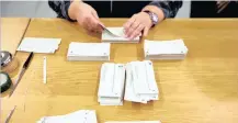  ?? Reuters
| ?? A MEMBER of the district election office sorts ballots in Zurich, Switzerlan­d, yesterday.