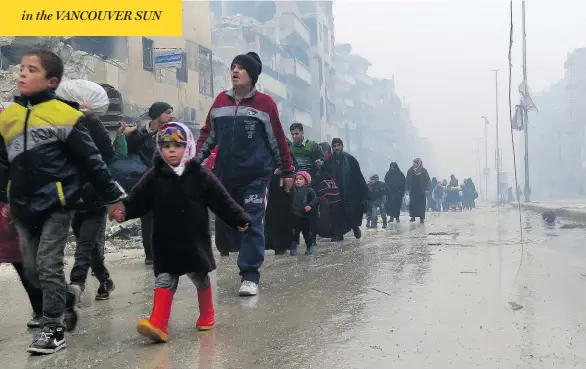  ?? AFP / GETTY IMAGES ?? Syrian residents arrive in the Fardos neighbourh­ood of eastern Aleppo on Tuesday, after government troops retook the area from rebel fighters. Following months of horrific bombardmen­t, the rebels agreed to surrender in return for amnesty and the...