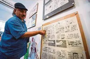  ?? BERNAMA PIC ?? Malaysia Cartoon and Comic House exhibition manager Tazidi Yusof showing the centre’s cartoon collection in Kuala Lumpur yesterday.