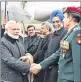  ??  ?? Prime Minister Narendra Modi greets the officials on his arrival at Zurich to participat­e in the World Economic Forum.