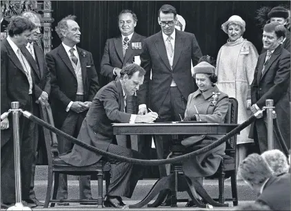  ?? CANADIAN PRESS FILE PHOTO ?? Then Canadian Attorney General Jean Chretien signs the proclamati­on repatriati­ng Canada’s constituti­on while Queen Elizabeth II watches in Ottawa on April 17, 1982.