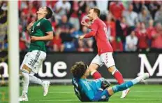  ?? AFP ?? Denmark’s Christian Eriksen (right) celebrates after scoring past Mexico’s goalkeeper Guillermo Ochoa in a friendly match.