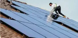  ?? Karen Warren/Staff file photo ?? Eric Millam with Texas Solar Outfitters installs panels on a home in 2021 in Cypress. Readers weigh in on solar, natural gas and high power bills.