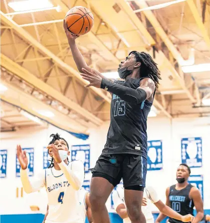  ?? VINCENT D. JOHNSON/DAILY SOUTHTOWN ?? Hillcrest’s Isaiah Green goes in for layup as Bloom’s Jordan Brown watches during Wednesday night’s game in the Chicago Heights Classic.