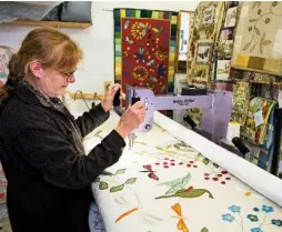  ??  ?? Louise uses the long-arm machine, which allows her to manoeuvre the quilt under the needle.