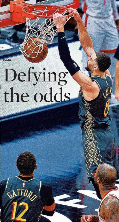  ?? Zach LaVine goes in for a two-handed dunk in January against the Rockets. TERRENCE ANTONIO JAMES/CHICAGO TRIBUNE ??