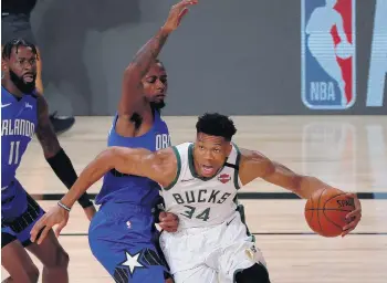  ?? KEVIN C. COX/GETTY IMAGES ?? Milwaukee’s Giannis Antetokoun­mpo drives against the Orlando Magic during the first quarter Saturday.