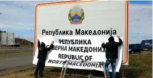  ?? (Ognen Teofilovsk­i/Reuters) ?? WORKERS SET UP a sign with the new name at the border between Macedonia and Greece, near Gevgelija, yesterday. The sign reads: ‘Republic of North Macedonia.’