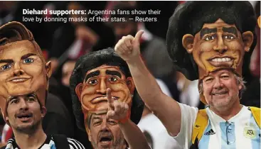  ?? — reuters ?? Diehard supporters: argentina fans show their love by donning masks of their stars.