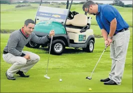  ?? Picture: FREDLIN ADRIAAN ?? GREEN TO GO: Humewood PGA apprentice Jacques Colananni, left, checks out club golf coordinato­r Ryle Lohrentz’s putting style ahead of the Chevrolet Festival of Links Golf, starting at the club on Sunday