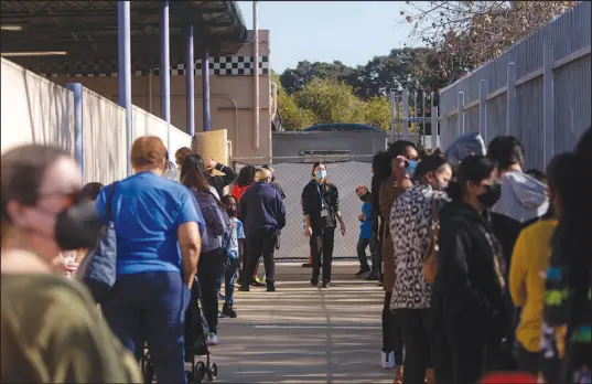  ?? ALLISON ZAUCHA / NEW YORK TIMES FILE ?? Students, families and teachers line up for COVID-19 tests Jan. 6 at Gardena High School in Gardena, Calif. The pandemic has supercharg­ed the decline in the nation’s public school system in ways that experts say will not easily be reversed.