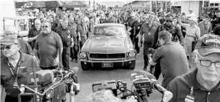  ?? PATRICK CONNOLLY/ORLANDO SENTINEL PHOTOS ?? ABOVE: “Bullitt,” a famous 1968 Mustang GT driven by Steve McQueen in the 1968 movie of the same name, is pictured Friday before it sold for $3.74 million at Mecum Kissimmee auction. BELOW: Sean Kiernan spends a few more minutes with “Bullitt” before the auction.