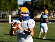  ??  ?? Brawley Union High quarterbac­k Jacob Ramirez scans the field for an open receiver during a team practice held Wednesday afternoon at BUHS in Brawley. PHOTO VINCENT OSUNA