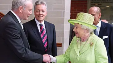  ??  ?? The most difficult handshake: The Queen greets McGuinness in 2012