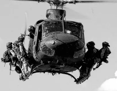  ?? SGT. DONALD CLARK • DND ?? Troops from the Canadian Special Operations Regiment prepare to rappel from a CH-146 Griffon helicopter during a training exercise near Kamloops, B.C.