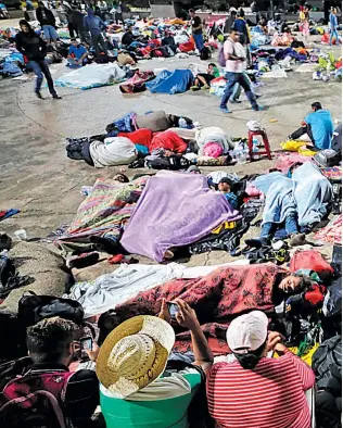  ??  ?? AL AIRE LIBRE. INMIGRANTE­S QUE VIAJAN EN LA CARAVANA DESCANSAN EN EL JARTÍN DE HIDALDO, EN TAPACHULA, MÉXICO.