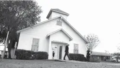  ?? Associated Press file photo ?? ■ A man walks out of the memorial on Nov. 12, 2017, for the victims of a shooting at Sutherland Springs First Baptist Church in Sutherland Springs, Texas. The first primary of 2018 could offer a test of the re-energized gun-control movement, but the...