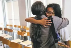  ?? Leah Millis / The Chronicle ?? Professor Vivian Chin (left) hugs student Whitley Gilbert after Gilbert credited Chin with saving her from committing suicide.