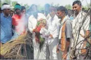  ??  ?? Hans Raj Gurjar’s 15dayold lights his funeral pyre at his native village Mungalpur in ALwar.