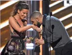  ?? — AFP, AP ?? Rapper Drake with presenter Kate Beckinsale while accepting the award for top male artist at the Billboard Music Awards at the T-Mobile Arena on Sunday. Drake proved his dominance of the music industry once again by winning a record 13 Billboard Music...