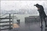  ?? AFP ?? A man is splashed by the swell from Victoria Harbour during heavy winds and rain brought on by Typhoon Hato in Hong Kong.